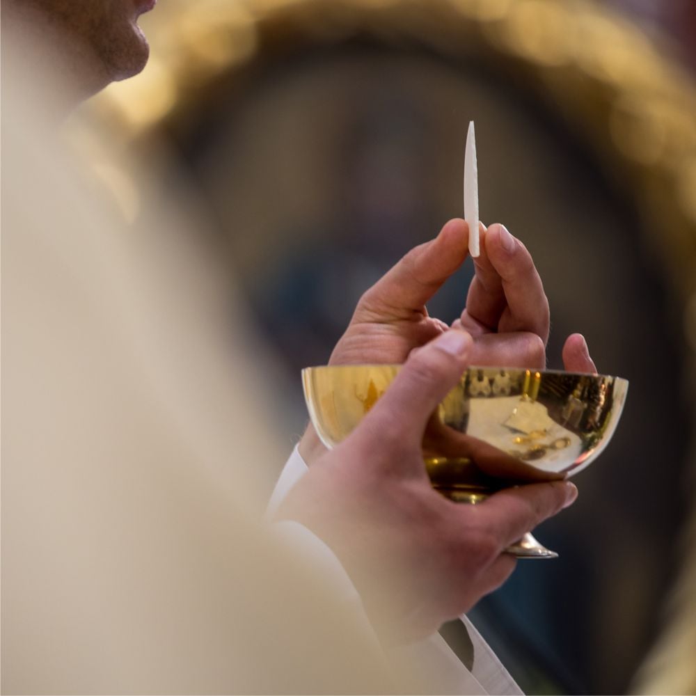 Priest giving communion